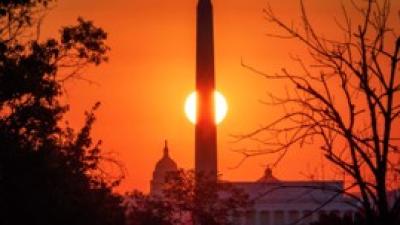 Sunset in background, tower in foreground, intersecting