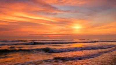 Sunset over ocean waves